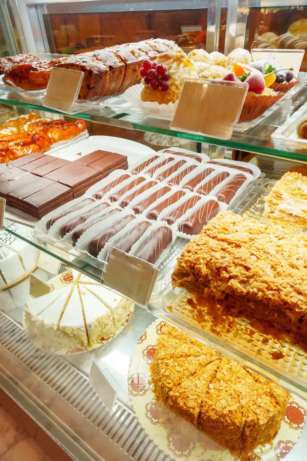 Assorted pastries and cakes in a bakery display case