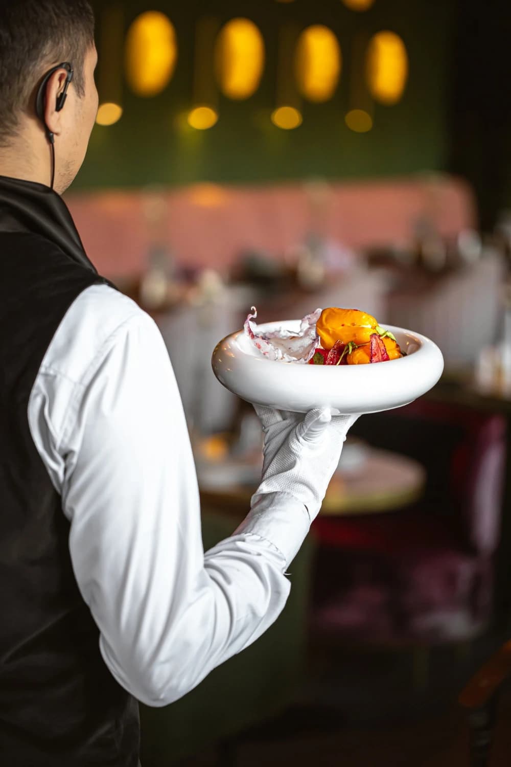 Waiter presenting a plated fine-dining dish